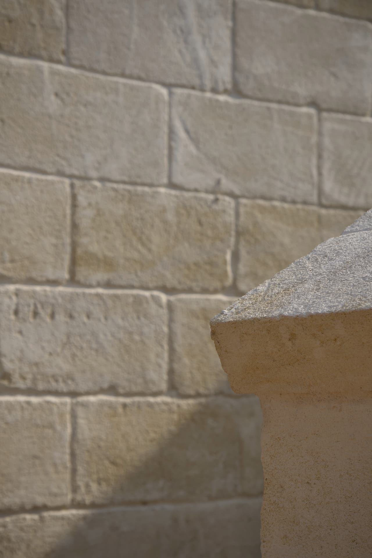 Close-up of hand-laid stone wall and rounded architectural detail